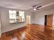 Spacious living room featuring hardwood floors, ceiling fan, and an open-concept view to the renovated kitchen at 2089 Lenox Rd, Atlanta, GA 30324