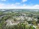 An aerial view of the neighborhood in a community with well-maintained lawns and mature trees at 2172 Misty Brook Ct, Buford, GA 30519
