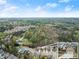 Community aerial view showcasing the neighborhood's layout, including an inset of a brick home at 2172 Misty Brook Ct, Buford, GA 30519