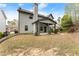 Two-story home exterior featuring a covered patio and backyard with mature trees at 2172 Misty Brook Ct, Buford, GA 30519