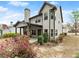 Exterior view of a two-story home with a patio and backyard with flowering bushes at 2172 Misty Brook Ct, Buford, GA 30519