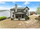 Backyard view featuring a covered porch with a brick fireplace and a grassy yard at 2172 Misty Brook Ct, Buford, GA 30519