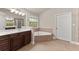 Bright Primary bath includes soaking tub, large vanity, walk-in shower and natural light at 2172 Misty Brook Ct, Buford, GA 30519