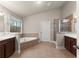 Primary bathroom featuring a glass-enclosed shower, tub, and dual vanities at 2172 Misty Brook Ct, Buford, GA 30519