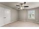 Neutral bedroom with carpet, ceiling fan, closet, and one window at 2172 Misty Brook Ct, Buford, GA 30519