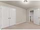 Bright bedroom features neutral walls and carpet with closet and entry doors at 2172 Misty Brook Ct, Buford, GA 30519