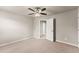 Neutral bedroom with carpet, ceiling fan, closet, and entry door at 2172 Misty Brook Ct, Buford, GA 30519