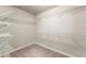 Walk-in closet featuring ample shelving and carpeted floor at 2172 Misty Brook Ct, Buford, GA 30519