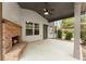 Covered patio features a brick fireplace, ceiling fan, and a view of the backyard at 2172 Misty Brook Ct, Buford, GA 30519