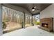 Covered patio boasts an outdoor fireplace and a peaceful backyard view at 2172 Misty Brook Ct, Buford, GA 30519