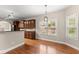 Sunlit dining area with hardwood floors, a modern light fixture and views of the neighborhood at 2172 Misty Brook Ct, Buford, GA 30519