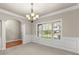 Formal dining room with carpet, classic trim, large windows, and a view to the kitchen at 2172 Misty Brook Ct, Buford, GA 30519