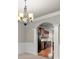 Open dining area with decorative chandelier, wainscoting, and seamless flow into the kitchen at 2172 Misty Brook Ct, Buford, GA 30519