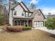 Beautiful two-story home features brick and siding exterior with lush landscaping and a two-car garage at 2172 Misty Brook Ct, Buford, GA 30519