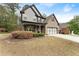 Charming two-story home featuring a brick and gray siding exterior, with a well-manicured lawn at 2172 Misty Brook Ct, Buford, GA 30519