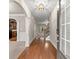 Inviting foyer with hardwood floors, arched doorways, and a view to the kitchen and staircase at 2172 Misty Brook Ct, Buford, GA 30519