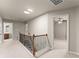 Upstairs hallway featuring carpet, wood and metal staircase and entry to the bedroom at 2172 Misty Brook Ct, Buford, GA 30519