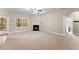 Bright living room featuring neutral carpet, a fireplace and an exterior door leading to the outside at 2172 Misty Brook Ct, Buford, GA 30519