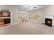 Open floor plan with fireplace, hardwood floors, and connection to the kitchen at 2172 Misty Brook Ct, Buford, GA 30519