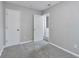 This bedroom has neutral paint with carpet flooring and bright white doors and trim at 5570 Downs Way, Lithonia, GA 30058