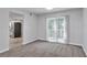 Open-concept dining area with access to the kitchen and sliding glass doors to the outside at 5570 Downs Way, Lithonia, GA 30058