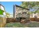 View of the back exterior of the home and the wooden deck overlooking the backyard at 5570 Downs Way, Lithonia, GA 30058