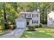 Charming two-story home features a manicured lawn, attached garage and lush landscaping at 5570 Downs Way, Lithonia, GA 30058
