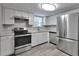 Modern kitchen featuring stainless steel appliances, white cabinets and durable flooring at 5570 Downs Way, Lithonia, GA 30058