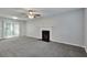 Spacious living room featuring a fireplace, new carpet, and sliding glass door to the outside at 5570 Downs Way, Lithonia, GA 30058