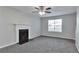 Spacious living room with new carpet, a cozy fireplace, and a large window at 5570 Downs Way, Lithonia, GA 30058