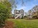 Large backyard with a mix of grassy lawn and natural wooded area at 791 Woodland Se Ave, Atlanta, GA 30316