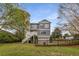 Expansive backyard with a large grassy area, wooden fencing, and a view of the home's exterior at 791 Woodland Se Ave, Atlanta, GA 30316