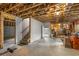 Unfinished basement with exposed wooden beams, a staircase, and potential for customization at 791 Woodland Se Ave, Atlanta, GA 30316