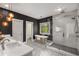 Stunning bathroom with soaking tub, glass enclosed shower, and patterned tile floor in a room with black accent walls at 791 Woodland Se Ave, Atlanta, GA 30316