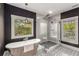 Bathroom featuring soaking tub, a glass-enclosed shower and patterned tile floor with a view from the window at 791 Woodland Se Ave, Atlanta, GA 30316