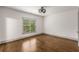 Simple bedroom with hardwood floors, bright windows, white walls and a modern ceiling fan at 791 Woodland Se Ave, Atlanta, GA 30316