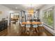 Dining room with hardwood floors and modern lighting, leading to an open kitchen and bright windows at 791 Woodland Se Ave, Atlanta, GA 30316