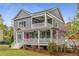Charming two-story home with a inviting porch and eye-catching pink doors at 791 Woodland Se Ave, Atlanta, GA 30316