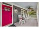 Welcoming front porch with rocking chairs, ceiling fans, and a pink front door at 791 Woodland Se Ave, Atlanta, GA 30316