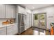Well-equipped kitchen with stainless appliances, gray cabinets, and access to outdoor deck at 791 Woodland Se Ave, Atlanta, GA 30316