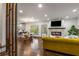 Open-concept living room with hardwood floors, fireplace, and seamless flow into dining area at 791 Woodland Se Ave, Atlanta, GA 30316