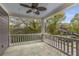 Covered porch with railing and patterned tile floor, offering a view of the neighborhood and the trees at 791 Woodland Se Ave, Atlanta, GA 30316