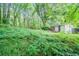 A beautiful backyard full of lush vegetation and mature trees with a view of the home at 1753 Thomas Ter, Decatur, GA 30032