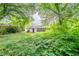 A beautiful backyard full of lush vegetation and mature trees with a view of the home at 1753 Thomas Ter, Decatur, GA 30032