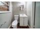 Bathroom featuring a single sink vanity and toilet with laminate flooring at 1753 Thomas Ter, Decatur, GA 30032