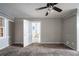 Bedroom with plush carpet, gray walls, and a ceiling fan, with a doorway leading to the rest of the house at 1753 Thomas Ter, Decatur, GA 30032