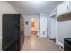 Kitchen with linoleum tile floor, black fridge, and white cabinets, offering access to other rooms in the home at 1753 Thomas Ter, Decatur, GA 30032