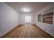 An inviting living room features hardwood floors, soft pink walls, and natural light from the window at 1753 Thomas Ter, Decatur, GA 30032
