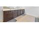 A close up of the vanity in the bathroom with dark cabinets and gray mats at 312 Amble Side, Mcdonough, GA 30252