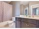 Standard bathroom featuring a shower-tub combo and a dark vanity with a white countertop at 312 Amble Side, Mcdonough, GA 30252